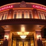 Caesars Palace at night with glowing entrance
