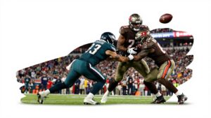 Eagles and Buccaneers football players in intense game action.