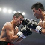 Boxing match action shot with blurred stadium lights.