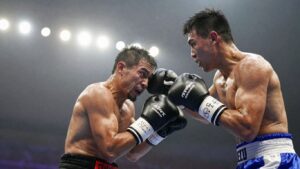 Boxing match action shot with blurred stadium lights.