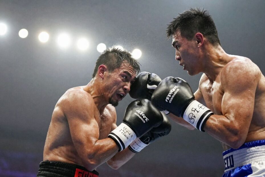 Boxing match action shot with blurred stadium lights.