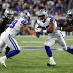 Cowboys vs. Raiders football game action shot.