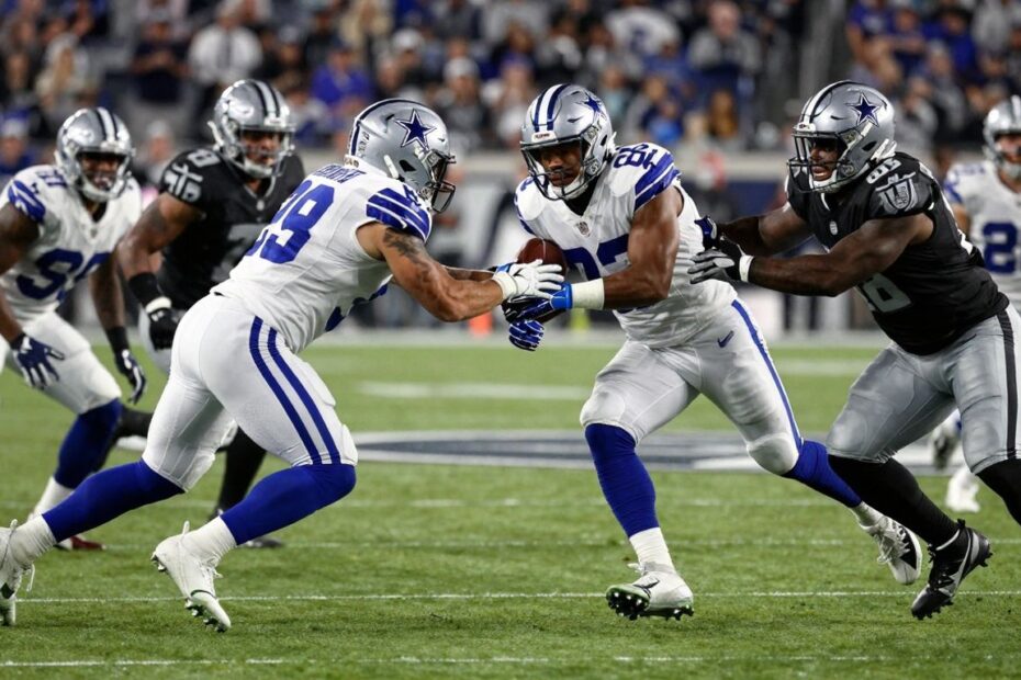 Cowboys vs. Raiders football game action shot.