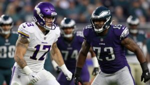 Vikings and Eagles football players in intense action.