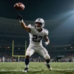 Football player scoring a touchdown in a stadium.