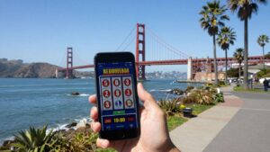 California coastline with smartphone showing online gambling.