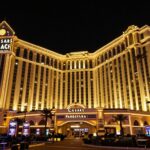 Caesars Palace sign at night, casino lights