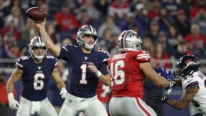 NFL players in action during a touchdown play.