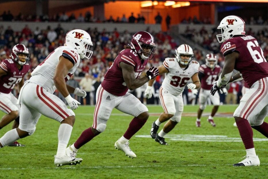 College football players on a field during a game.